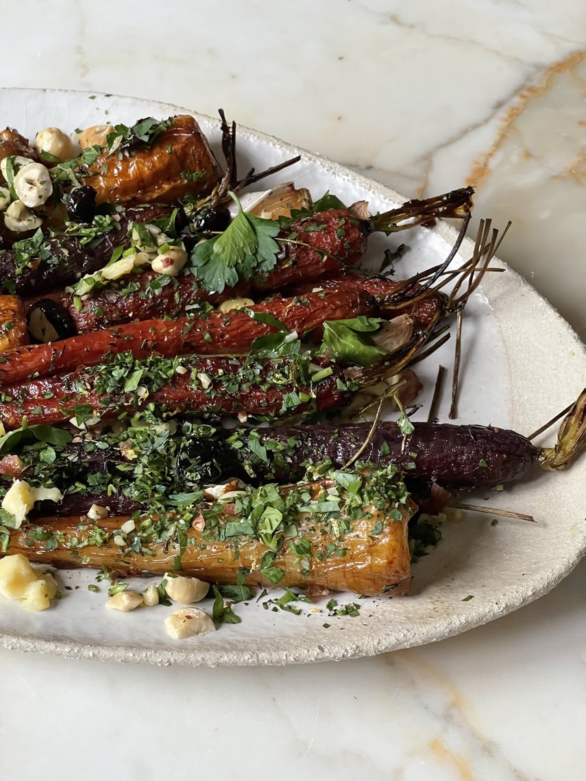 A rustic bowl of roasted vegetables arranged artfully to showcase different shapes and colors.