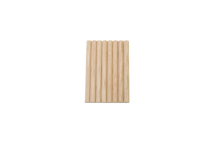 Detail of a curved kitchen island faced with Tasmanian oak half-dowels.